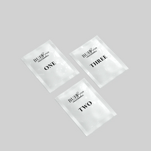 Load image into Gallery viewer, Three clear packets labeled 'ONE', 'TWO', and 'THREE' on a gray background