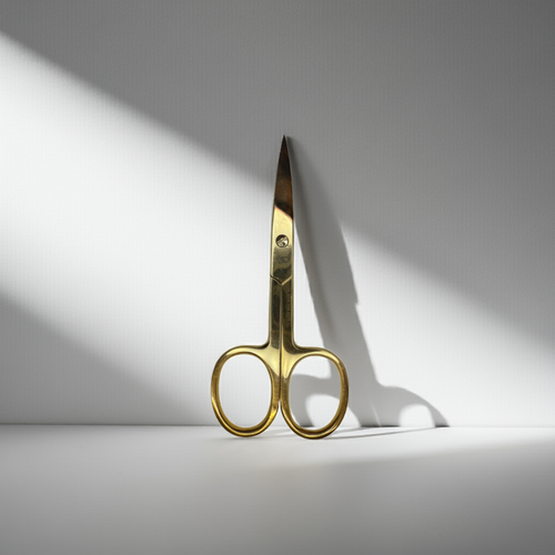 Gold scissors on a white background